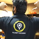 Planet Kuching logo on the back of a team shirt
