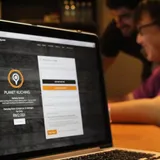 The Planet Kuching website on a laptop: order anything in Kuching, delivered for RM2